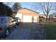 Attached garage with parking space and a side yard featuring a green lawn and mature trees at 5819 Bar Del E Dr, Indianapolis, IN 46221