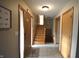 Inviting entryway with tiled flooring, decorative front door, and stairway to the upper level at 5819 Bar Del E Dr, Indianapolis, IN 46221