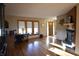 Open-concept living area with hardwood floors, a fireplace, and large windows for ample natural light at 5819 Bar Del E Dr, Indianapolis, IN 46221