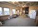 Large sunroom with ample windows, neutral carpet, ceiling fan, and access to the kitchen and exterior at 5819 Bar Del E Dr, Indianapolis, IN 46221