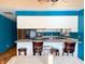 Bright eat-in kitchen with white cabinets, black appliances, and stylish breakfast bar at 619 Heritage Ln, Anderson, IN 46013
