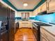 Well-lit kitchen featuring white cabinets, dark appliances, and hardwood floors at 619 Heritage Ln, Anderson, IN 46013