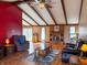 Inviting living room with hardwood flooring, brick fireplace, exposed beams, and plenty of natural light at 619 Heritage Ln, Anderson, IN 46013