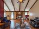 Cozy living room with exposed beam ceiling, brick fireplace, and hardwood flooring at 619 Heritage Ln, Anderson, IN 46013