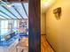 View of a spacious living room featuring a brick fireplace and hardwood floors, as seen from an adjacent hallway at 619 Heritage Ln, Anderson, IN 46013