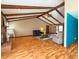 Spacious living room boasts hardwood floors, exposed beam ceiling, fireplace, and plenty of space at 619 Heritage Ln, Anderson, IN 46013