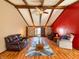 Spacious living room features wood beam vaulted ceilings, a ceiling fan, hardwood floors, and comfortable seating at 619 Heritage Ln, Anderson, IN 46013