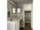 Bathroom vanity featuring a sink and a mirror with modern lighting fixtures at 6640 Manassas Dr, Indianapolis, IN 46241