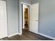 Bedroom featuring neutral walls, wood-look flooring, an open doorway to a bathroom at 6640 Manassas Dr, Indianapolis, IN 46241