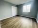 Bedroom featuring neutral walls, wood-look flooring, closet, and a window at 6640 Manassas Dr, Indianapolis, IN 46241