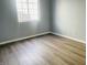 Bedroom featuring neutral walls, wood-look flooring, and a window at 6640 Manassas Dr, Indianapolis, IN 46241