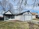 Charming home featuring a two-car garage and classic architectural details at 6640 Manassas Dr, Indianapolis, IN 46241