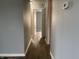 Inviting hallway featuring laminate flooring that leads to various rooms at 6640 Manassas Dr, Indianapolis, IN 46241