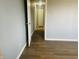 Hallway featuring neutral walls and wood-look flooring leading to various rooms at 6640 Manassas Dr, Indianapolis, IN 46241