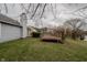 Expansive yard with wood deck provides an inviting outdoor space with lush grass at 7352 Crickwood Pl, Indianapolis, IN 46268