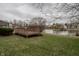 Large backyard deck sits on a lot with lush green grass with a lovely water view at 7352 Crickwood Pl, Indianapolis, IN 46268