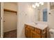 Bright bathroom with oak vanity, white countertop, open closet access and tile flooring at 7352 Crickwood Pl, Indianapolis, IN 46268
