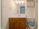 Well lit bathroom featuring a white countertop and oak cabinets at 7352 Crickwood Pl, Indianapolis, IN 46268