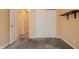 A neutral-toned bedroom featuring a sliding door closet and a minimalistic design with a wall mounted shelf at 7352 Crickwood Pl, Indianapolis, IN 46268