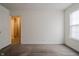A room with neutral walls and carpet, with natural light streaming through the window at 7352 Crickwood Pl, Indianapolis, IN 46268