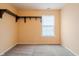 Bedroom featuring carpet, neutral walls, mounted shelving and natural light from a window at 7352 Crickwood Pl, Indianapolis, IN 46268