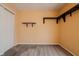 Cozy bedroom with carpet, a white door, and black shelving accents at 7352 Crickwood Pl, Indianapolis, IN 46268