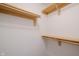 Walk-in closet featuring built-in wooden shelving for optimal storage at 7352 Crickwood Pl, Indianapolis, IN 46268