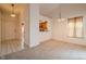 Open-concept view of the entry and dining area featuring tile flooring and neutral carpeting at 7352 Crickwood Pl, Indianapolis, IN 46268