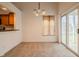 Carpeted dining area with sliding glass door and views of the kitchen through a pass-through window at 7352 Crickwood Pl, Indianapolis, IN 46268