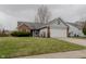 Charming single-story home featuring a brick and gray exterior with an attached two-car garage at 7352 Crickwood Pl, Indianapolis, IN 46268