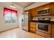 Bright kitchen featuring wood cabinets, stainless steel appliances, and a window with natural light at 7352 Crickwood Pl, Indianapolis, IN 46268