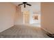 Spacious living room featuring neutral paint, carpet, and ceiling fan, open to kitchen and front door at 7352 Crickwood Pl, Indianapolis, IN 46268