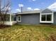 Backyard view showcasing the home's siding, large windows, and sunroom at 7850 Park North Bnd, Indianapolis, IN 46260