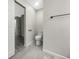 Modern half bathroom featuring a toilet, towel bar, and tile floors at 7850 Park North Bnd, Indianapolis, IN 46260