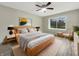 Bright bedroom featuring a ceiling fan, large window, modern decor, and light wood flooring at 7850 Park North Bnd, Indianapolis, IN 46260