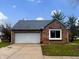 Charming brick home with a two-car garage and well-maintained lawn on a sunny day at 7850 Park North Bnd, Indianapolis, IN 46260