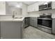 Modern kitchen featuring stainless steel appliances, gray cabinets, and granite countertops at 7850 Park North Bnd, Indianapolis, IN 46260