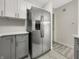 Kitchen with stainless steel refrigerator and white and gray cabinets at 7850 Park North Bnd, Indianapolis, IN 46260