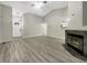 Open-concept living room with a fireplace and modern flooring at 7850 Park North Bnd, Indianapolis, IN 46260