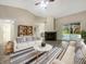 Bright living room with vaulted ceilings, fireplace, and sliding door access to the outdoors at 7850 Park North Bnd, Indianapolis, IN 46260
