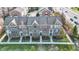 Aerial view shows townhomes with gardens, sidewalks, and well-maintained landscaping at 8613 N Meridian St, Indianapolis, IN 46260