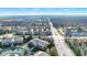Aerial view shows townhomes and roadways lined with green spaces and bright skies at 8613 N Meridian St, Indianapolis, IN 46260