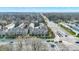 Aerial community view showcases townhomes, trees, and street access offering a glimpse of neighborhood living at 8613 N Meridian St, Indianapolis, IN 46260