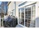 Back deck with a grill and sliding glass doors to the interior at 8613 N Meridian St, Indianapolis, IN 46260