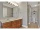 Functional bathroom with double sinks, wood cabinets, and separate toilet area at 8613 N Meridian St, Indianapolis, IN 46260
