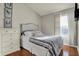 Cozy bedroom with a full-sized bed, white dresser, and lots of natural light at 8613 N Meridian St, Indianapolis, IN 46260
