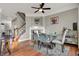 Bright dining room featuring a glass table, modern chairs, fireplace, and stylish decor at 8613 N Meridian St, Indianapolis, IN 46260