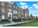 Attractive townhome exteriors with brick facade, complemented by well-maintained lawns and sidewalks at 8613 N Meridian St, Indianapolis, IN 46260