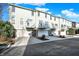Three-story townhomes boasting balconies and attached garages offer modern living spaces at 8613 N Meridian St, Indianapolis, IN 46260