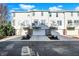 Row of three-story townhomes featuring attached garages and private balconies for outdoor enjoyment at 8613 N Meridian St, Indianapolis, IN 46260